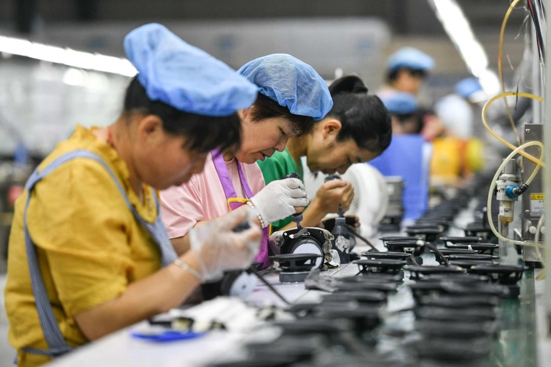 Employees work on an assembly line producing speakers at a factory in Fuyang in China’s eastern Anhui province. Photo: AFP