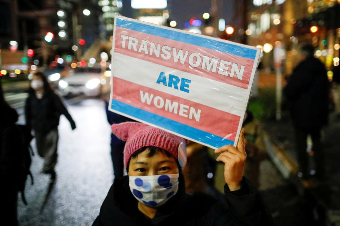 A demonstrator holds a placard during a march to call for gender equality and protest against gender discrimination in Tokyo, Japan, in March 2021. Photo: Reuters