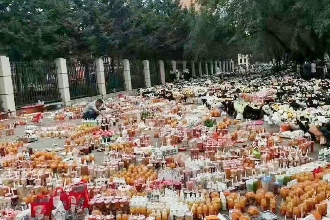 Bubble tea and snacks were laid outside the school in Qiqihar to honour the dead.  Photo: Weibo