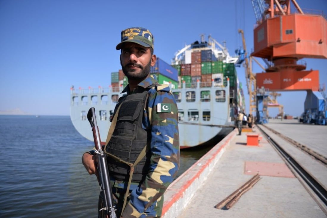 A member of the Pakistani navy stands guard near a container ship during the opening of a trade project in Gwadar port in 2016. Photo: AFP