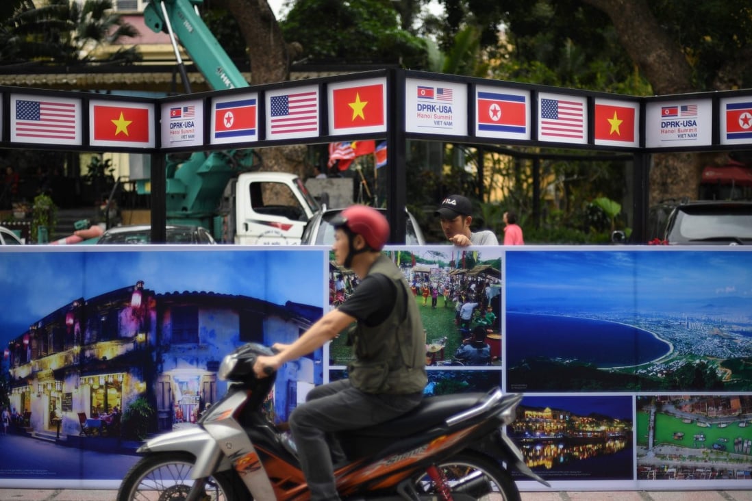 A Vietnamese worker dismantles a billboard in Hanoi on March 2, 2019, two days after the second US-North Korea summit between US President Donald Trump and North Korea’s leader Kim Jong-un. Photo: AFP