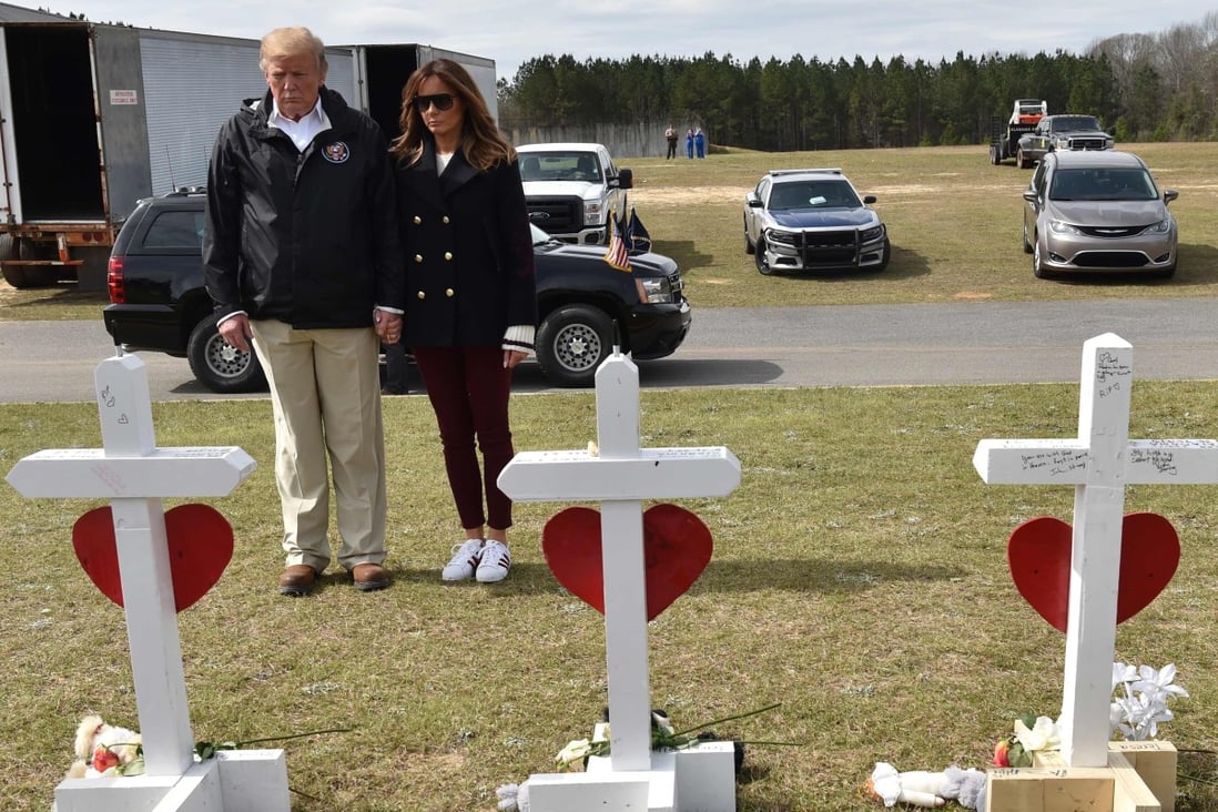 US President Donald Trump and First Lady Melania Trump stand before a row of crosses honouring 23 people who died in the storm outside Providence Baptist Church in Opelika, Alabama during a March 8 visit. Photo: AFP