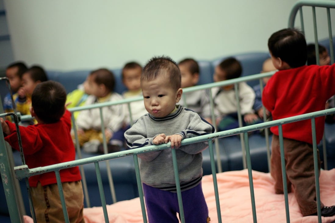 He Yue Ke, 2, stands inside a cot in Shanghai Children's Home orphanage in this 2005 file photo. That year, US adoptions of Chinese children peaked at 7.903; numbers have since fallen by more than 80 per cent. Photo: Reuters