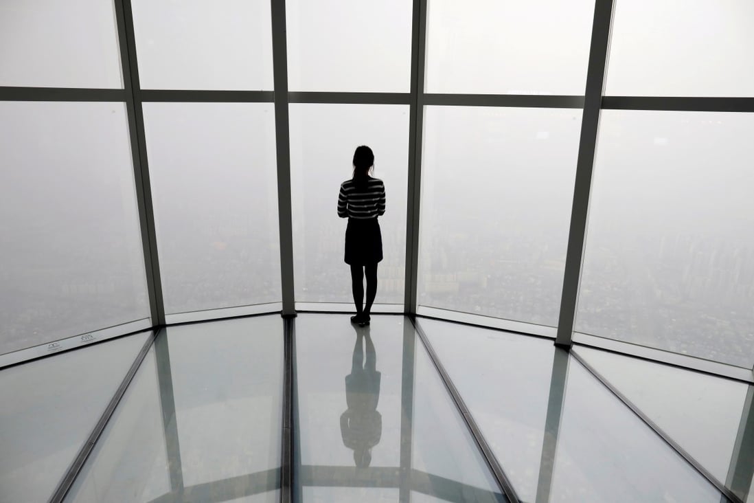 A woman looks at a view of Seoul shrouded by fine dust. Photo: Reuters