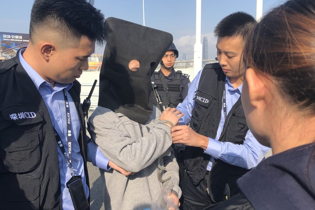 A fugitive is handed over to Hong Kong police by mainland authorities in December. Photo: Handout