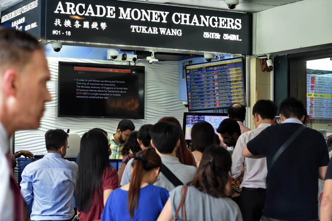 A money changer in the financial district in Singapore on June 9, 2017. Photo: AFP