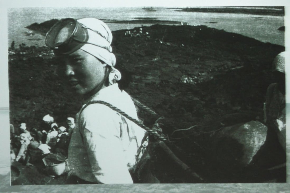 A vintage image of a Jeju diver shows the how little equipment they use to harvest seafood from the icy cold waters around the South Korean island.