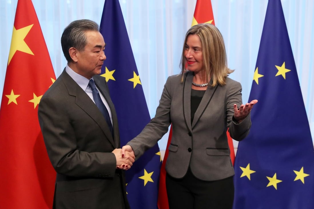 Chinese Foreign Minister Wang Yi is welcomed by EU foreign policy chief Federica Mogherini ahead of a meeting in Brussels. Photo: Reuters