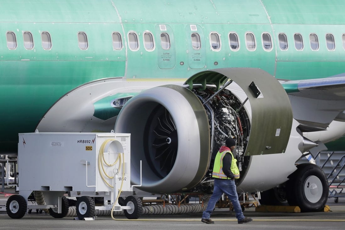 A worker walks past an engine on a Boeing 737 MAX 8 airplane being built for American Airlines at Boeing’s assembly plant in Renton, Washington, on March 13. Photo: AP