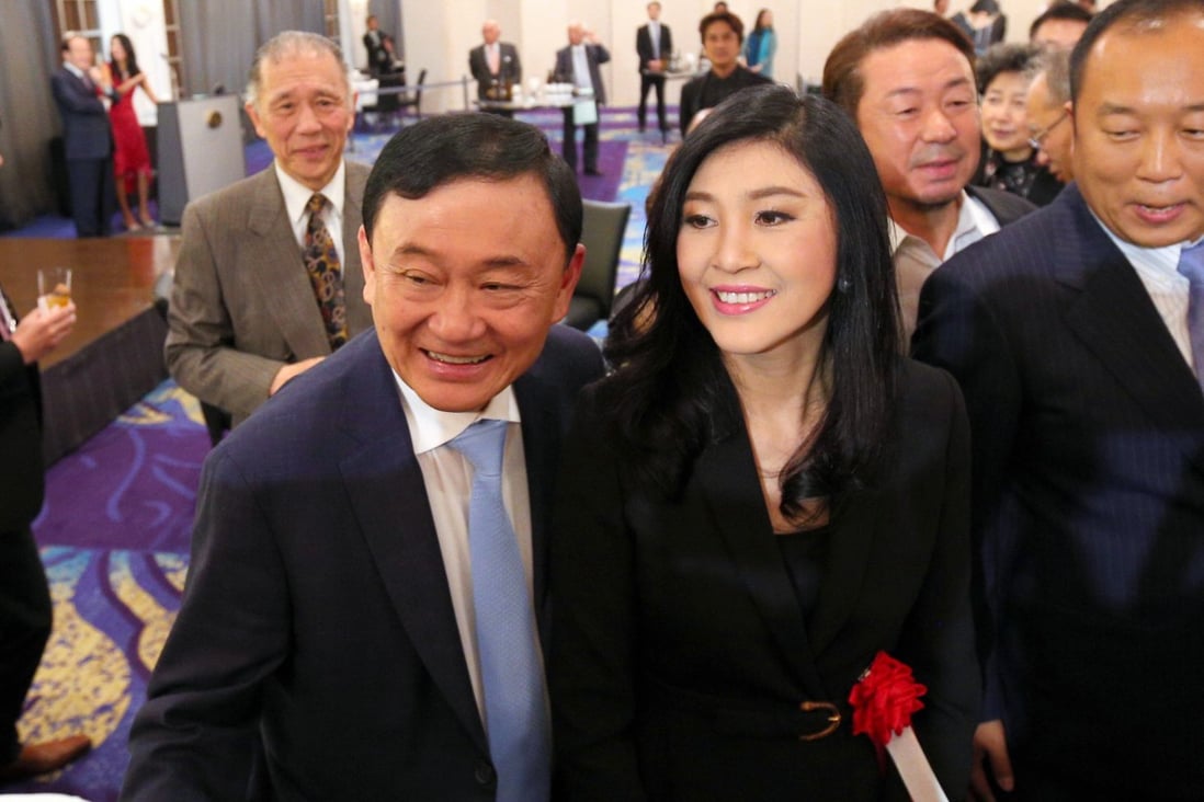 Thaksin and Yingluck Shinawatra during a trip to Tokyo last year. Photo: AFP