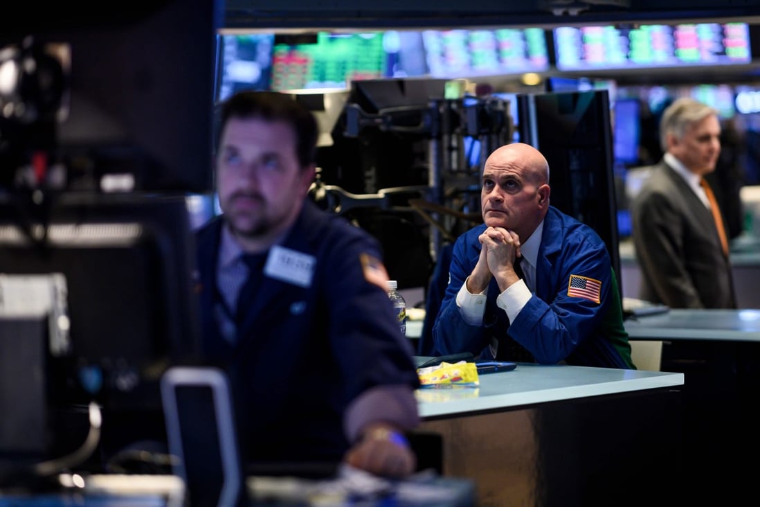 Traders work ahead of the closing bell on the floor of the New York Stock Exchange on March 18, on a day when stocks finished higher thanks to gains from petroleum companies and banks. Photo: AFP