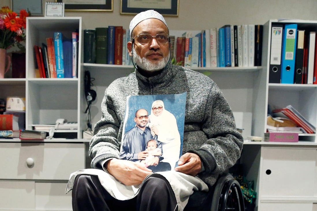 Farhid Ahmed holds a photo of his wife Husna, who was killed in the attack. Photo: Reuters