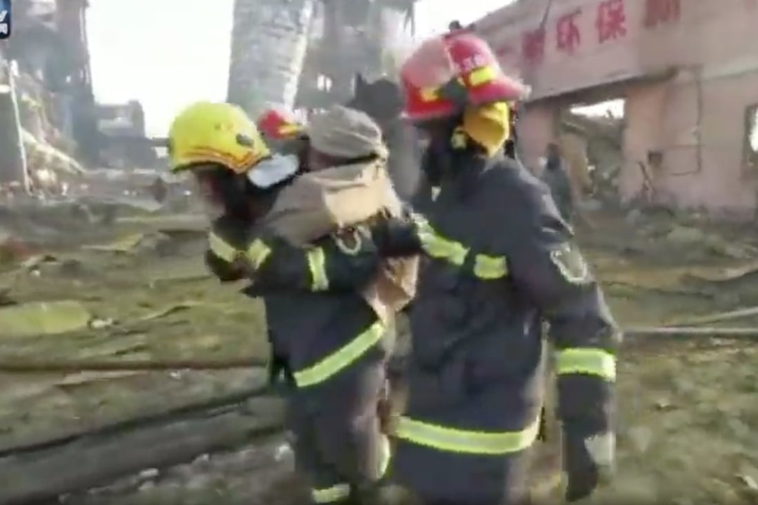 A firefighter carries a man to safety on Saturday morning, 40 hours after the deadly blast at a chemical plant in eastern China. Photo: Weibo