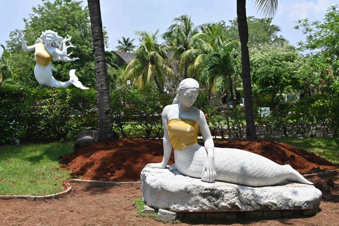 A pair of bare-breasted mermaid statues have been given some family values treatment at an Indonesian theme park. Photo: AFP