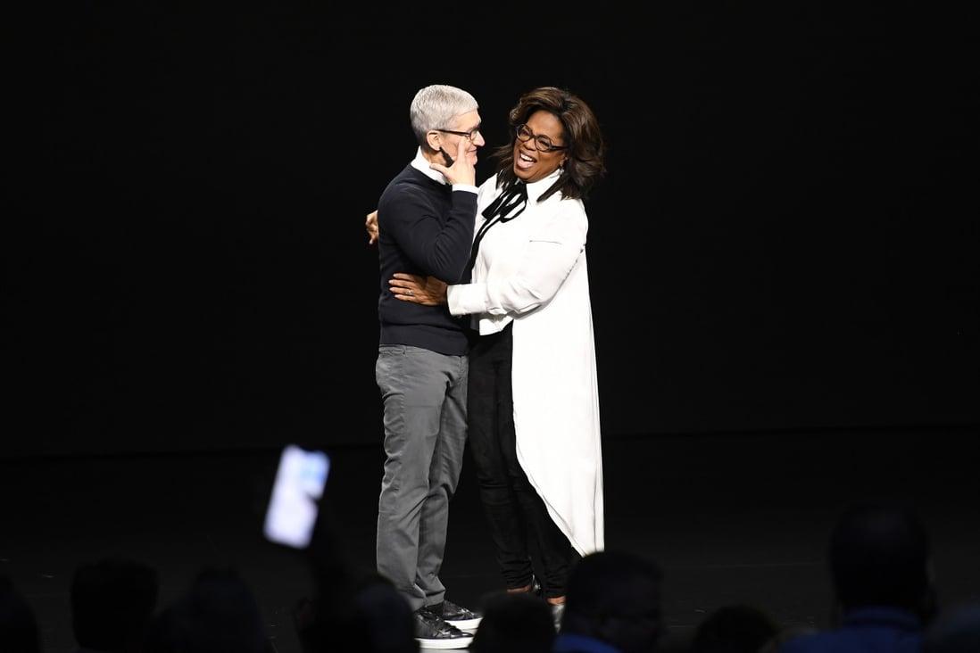 Tim Cook, chief executive officer of Apple Inc, and Oprah Winfrey laugh on stage at the Steve Jobs Theatre in Cupertino, California, on Monday. Photo: Bloomberg