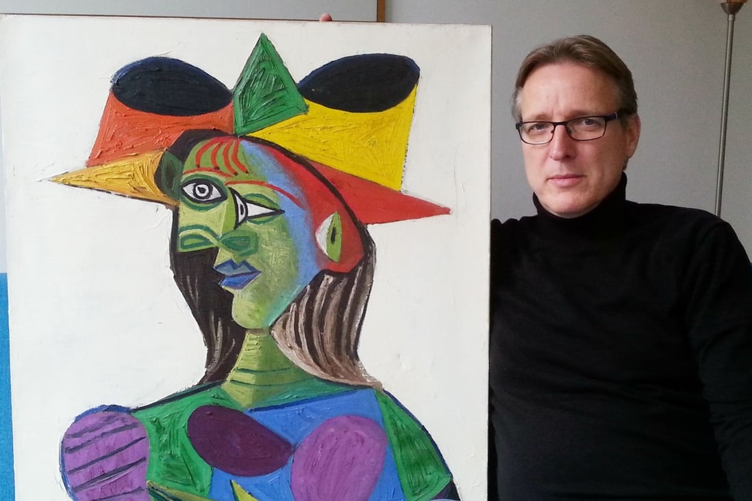 Art historian Arthur Brand posing with stolen Picasso painting Buste de Femme (Dora Maar). Photo: AFP