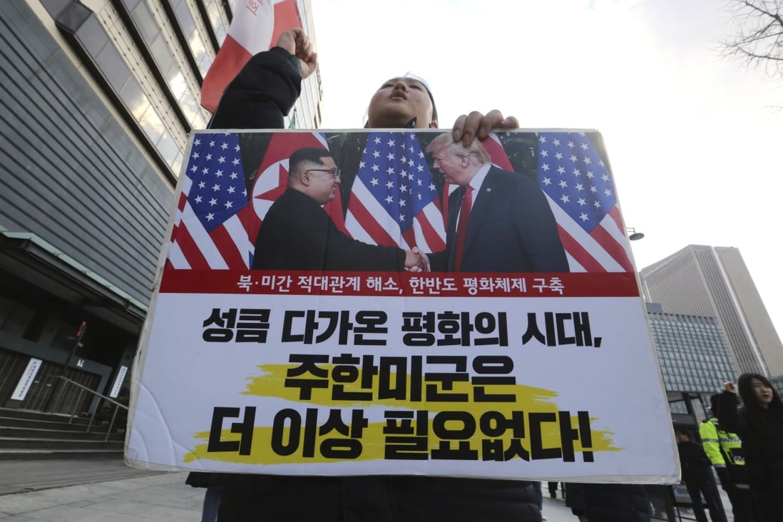 A protester holds a poster showing US President Donald Trump and North Korean leader Kim Jong-un during a rally against the United States’ policy on North Korea, near the US Embassy in Seoul on Saturday. Photo: AP
