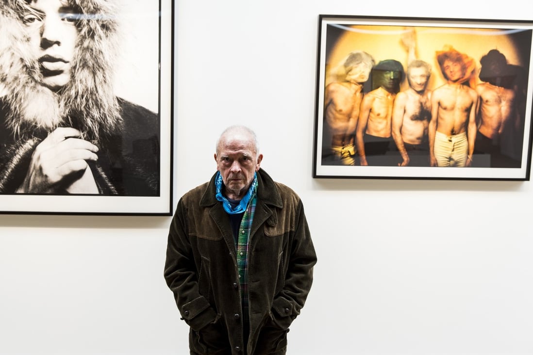English fashion and portrait photographer David Bailey poses in front of two of his images of British rock band The Rolling Stones which feature in a large-format Taschen book of his work. Photo: Jay Clendenin/Los Angeles Times/TNS)