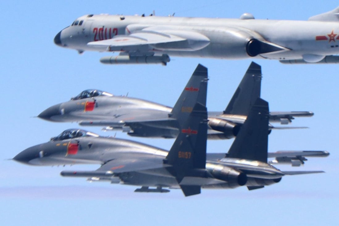 Two PLA Air Force J-11 fighters and a H-6K bomber patrol airspace between mainland China and Taiwan. Photo: Xinhua