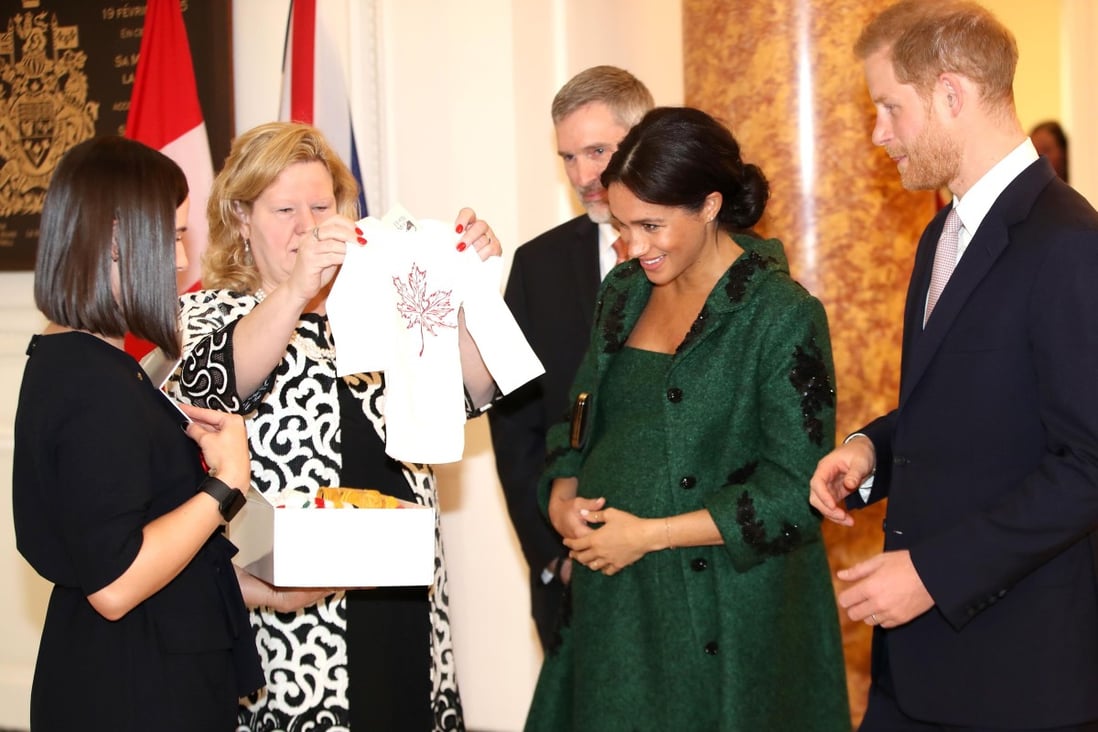 Meghan, Duchess of Sussex (second right) and Britain’s Prince Harry, Duke of Sussex (right), reacting as they are presented with baby gifts by the Canadian High Commissioner to the United Kingdom, Janice Charette (second left), at Canada House in the UK. Photo: AFP