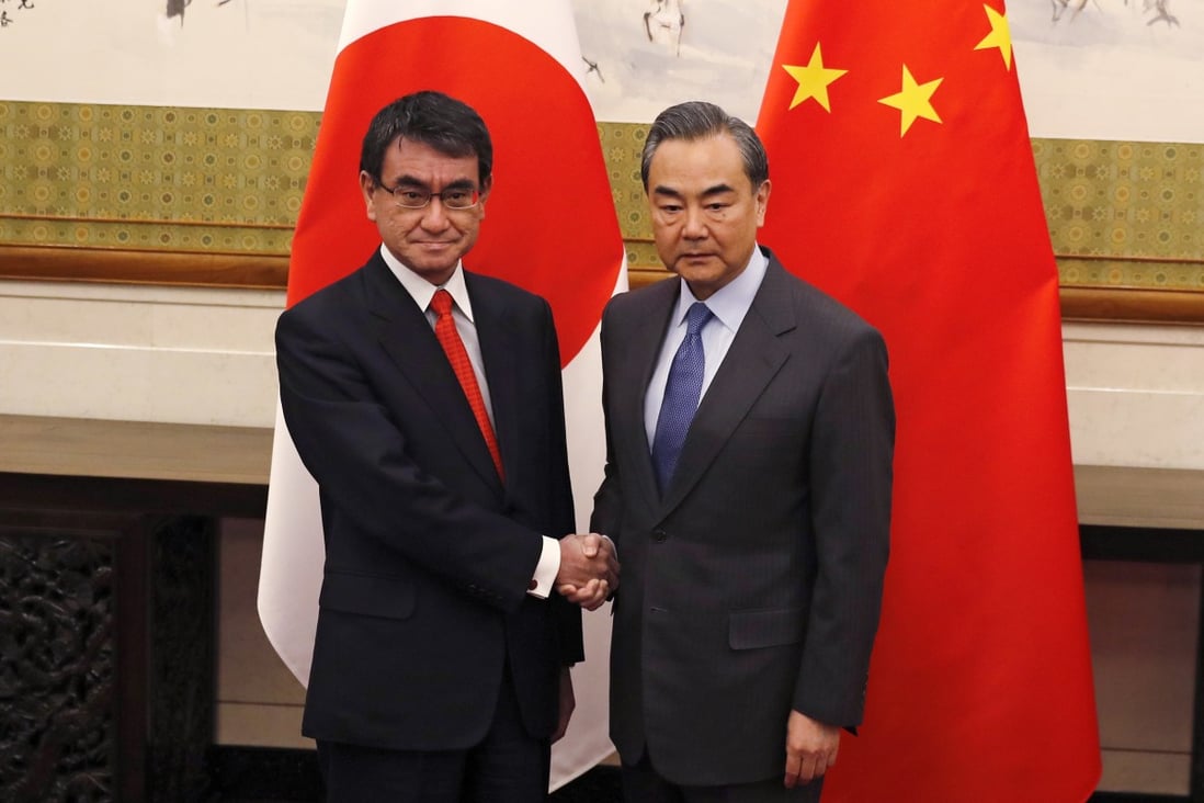 Japanese Foreign Minister Taro Kono, left, who will lead the delegation to bilateral economic talks in Beijing, and Chinese Foreign Minister Wang Yi. Photo: AP