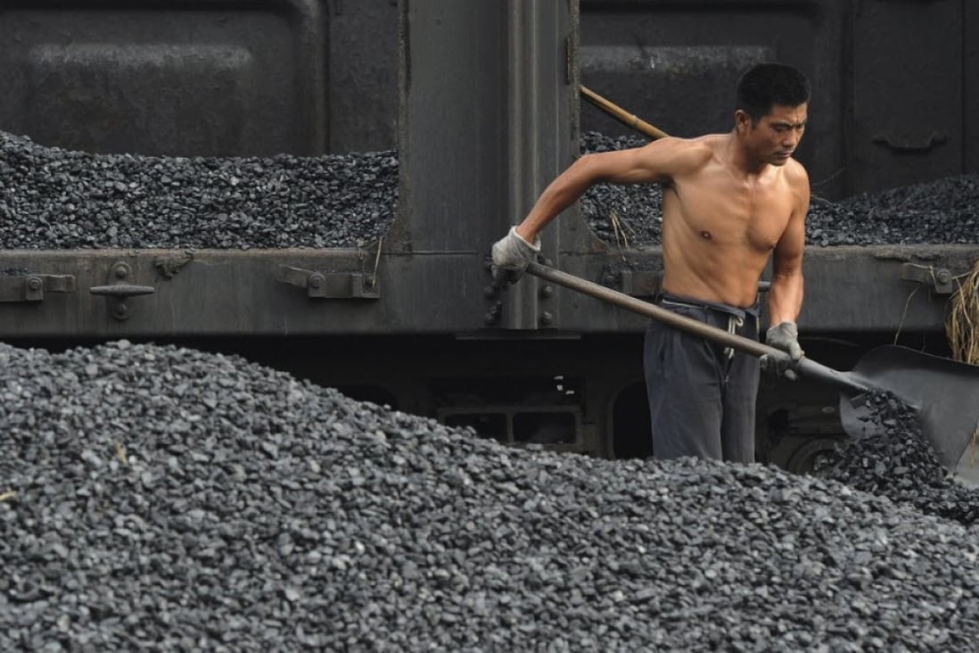A labourer shovels coal at a storage site in Hefei, in China’s Anhui province, in 2011. Photo: Reuters