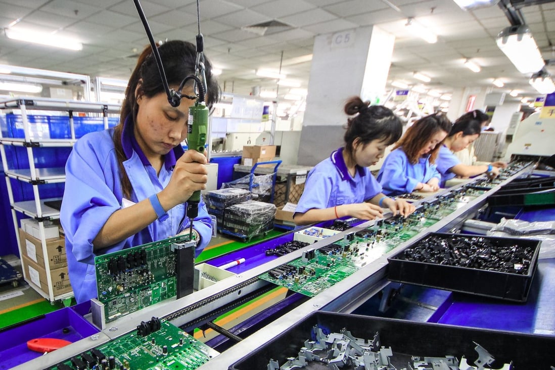 Workers at a production line manufacturing electronic keyboards in Tianjin, China. Photo: Reuters