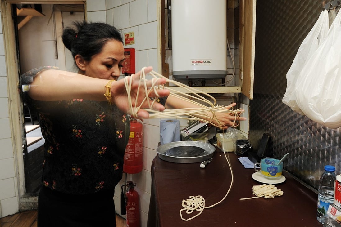 Mukaddes Yadikar from Etles Restaurant in London preparing laghman handmade noodles, a staple of Uygur kitchens. Photo: Mike Clarke