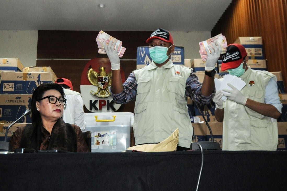 Officers from the corruption eradication commission with boxes of Indonesian currency totalling more than US$560,000. Photo: AFP