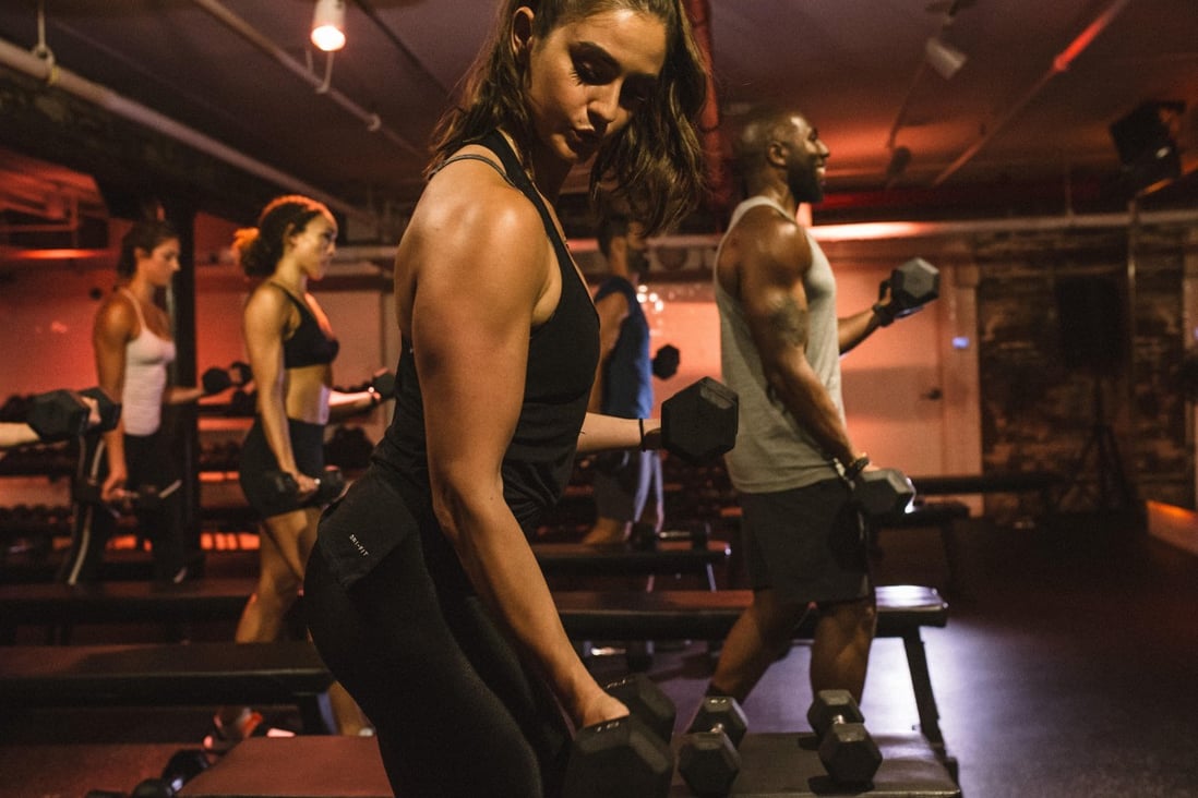 Liftonic is a gym where members can lift weights in a dark room.