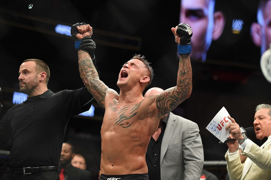 Dustin Poirier celebrates after receiving the title belt from UFC president Dana White. Photo: AFP