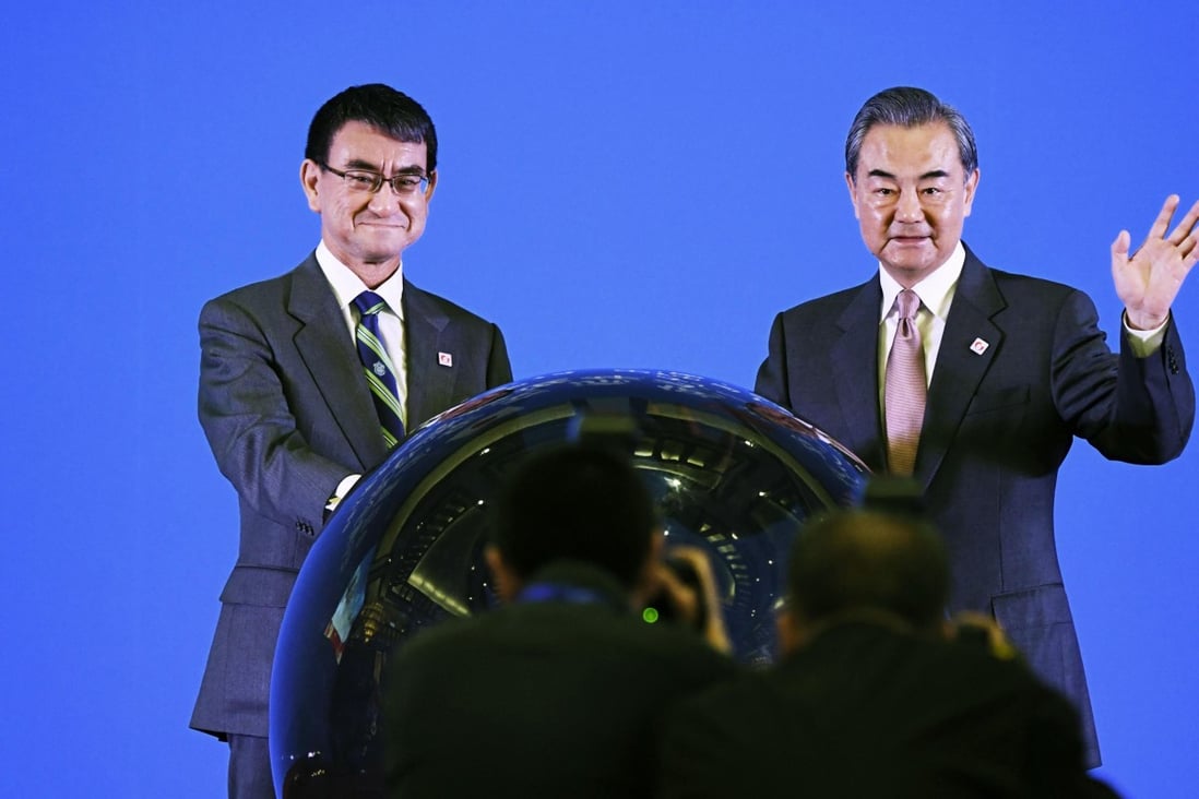 Japanese Foreign Minister Taro Kono (left) alongside his Chinese counterpart Wang Yi in Beijing on Sunday. Photo: Kyodo