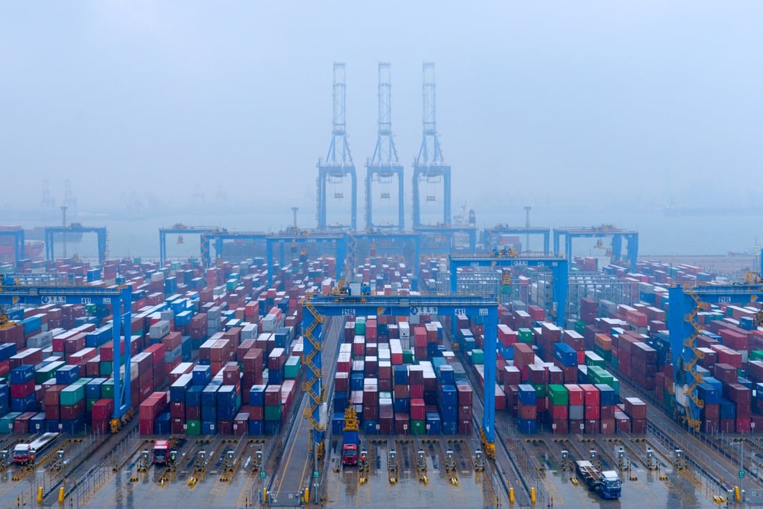 Containers and trucks are seen on a snowy day at an automated container terminal in Qingdao port, Shandong province, China. Photo: Reuters