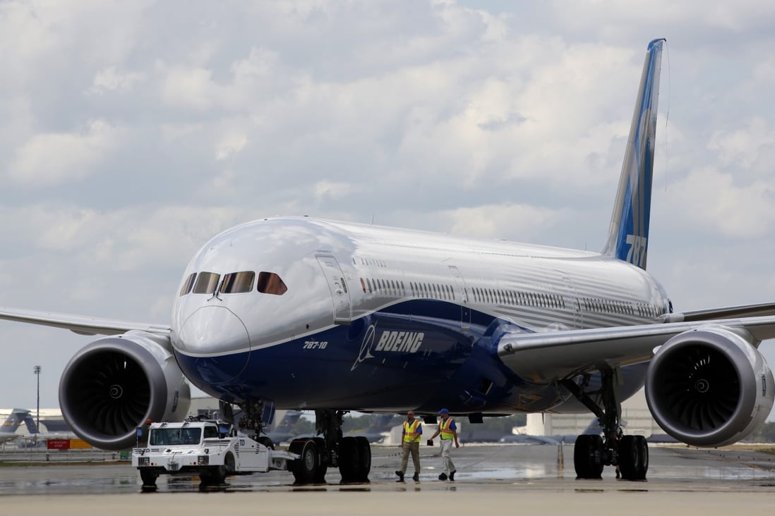 FILE – In this March 31, 2017, file photo, Boeing employees walk the new Boeing 787-10 Dreamliner down towards the delivery ramp area at the company's facility in South Carolina after conducting its first test flight at Charleston International Airport in North Charleston, S.C. Singapore Airlines says it has grounded two of its Boeing 787-10 aircraft due to engine issues. The carrier in a statement on Tuesday, April 2, 2019, that “premature blade deterioration was found on some engines” of its 787-10 fleet at recent routine inspections. (AP Photo/Mic Smith, File)