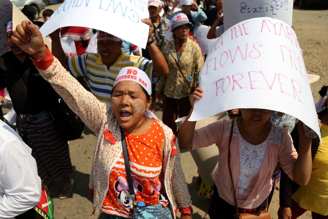 Kachin people and children hold placards during a protest against the Myitsone dam project on Monday. Photo: EPA-EFE