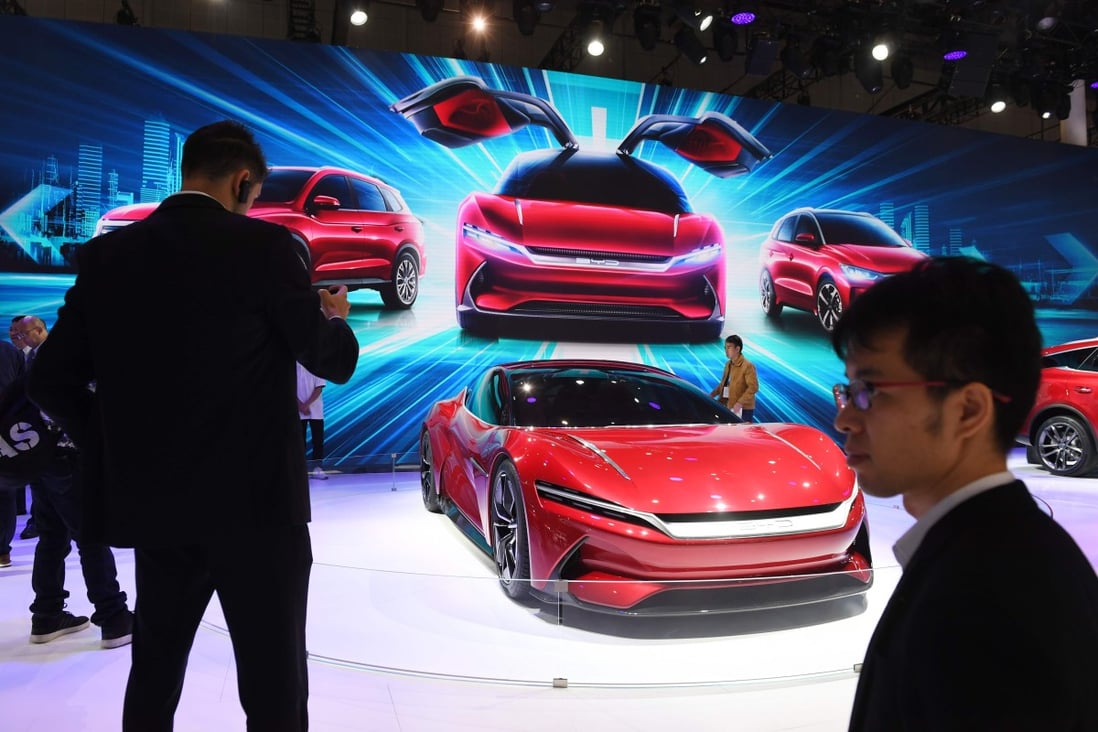 Visitors to the Shanghai Auto Show photograph the BYD E-SEED GT electric concept caron April 17, 2019. Photo: AFP