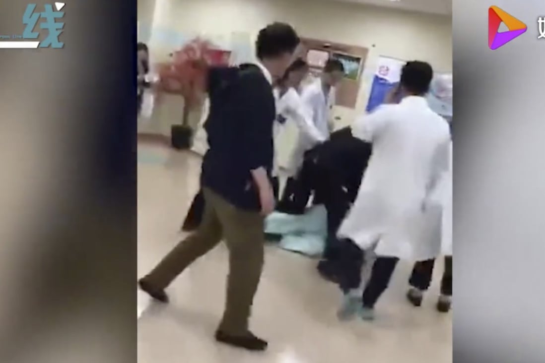 Police wrestled surgeon Zhao Xiaojing to the floor and took him away in handcuffs after he got into a fight with the husband of one of his patients. Photo: Weibo