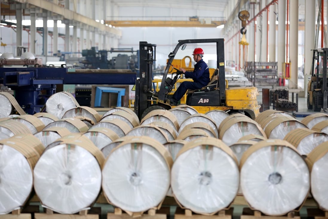 A worker drives a forklift past aluminium rolls at a factory in Huaibei, Anhui province, China. Photo: Reuters
