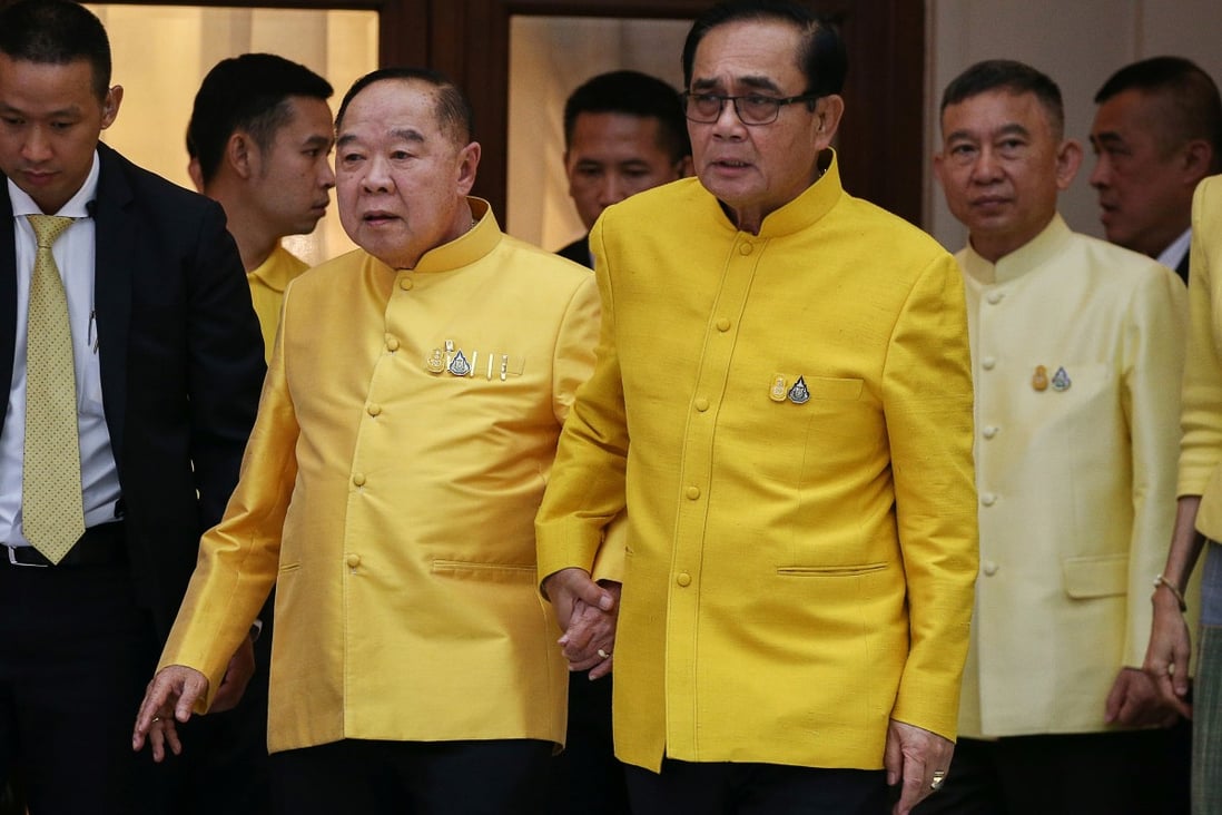 Thailand's Prime Minister Prayuth Chan-ocha holds hands with Deputy Prime Minister and Defence Minister Prawit Wongsuwon. Photo: Reuters