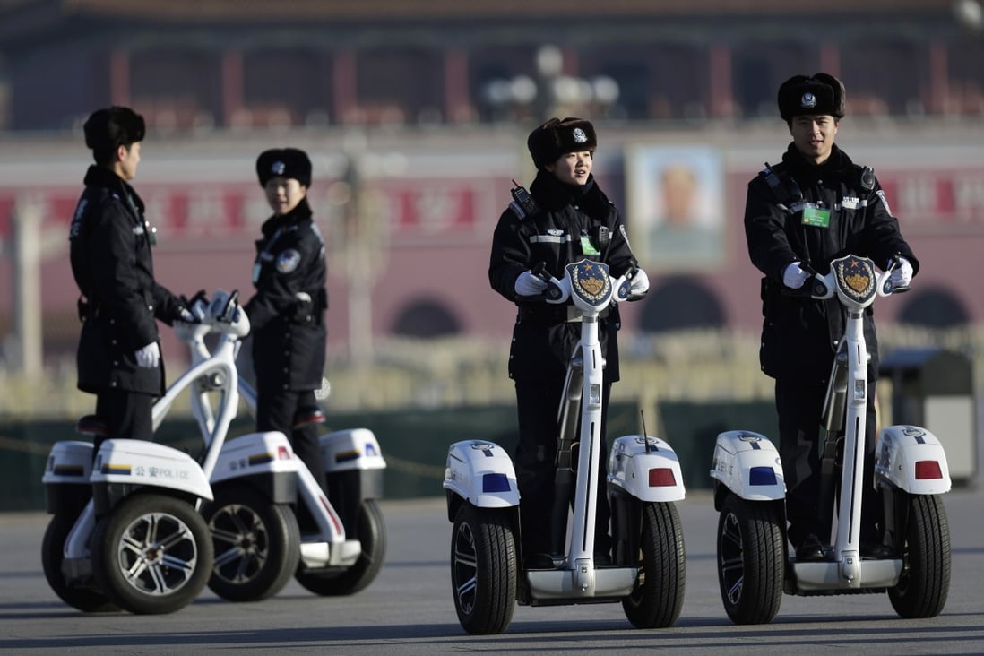 Police officers patrol Tiananmen Square on two-wheeled electric vehicles. Photo: AP