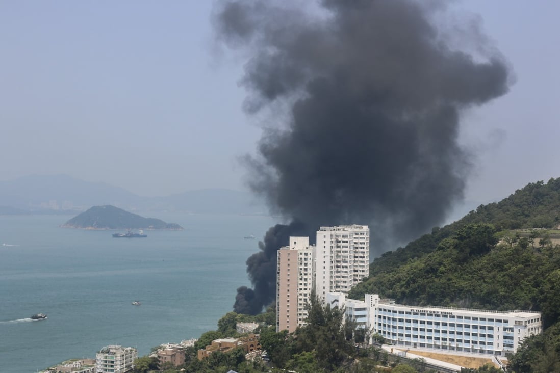 Smoke billowing from a yacht that caught fire off the west coast of Hong Kong Island on Saturday morning, injuring two people. Photo: Handout