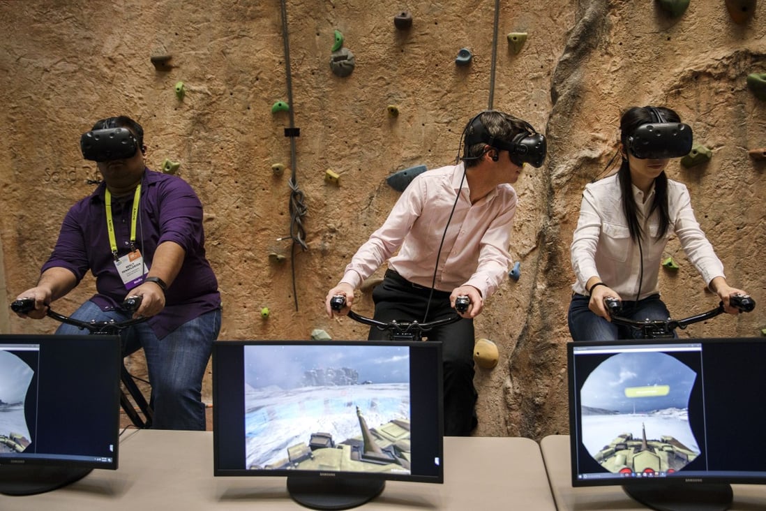 Attendees wear HTC Corp. Vive VR headsets while riding the VirZOOM Inc. bike gaming controller during the vSports Competition at the 2017 Consumer Electronics Show (CES) in Las Vegas, US. Photo: Bloomberg