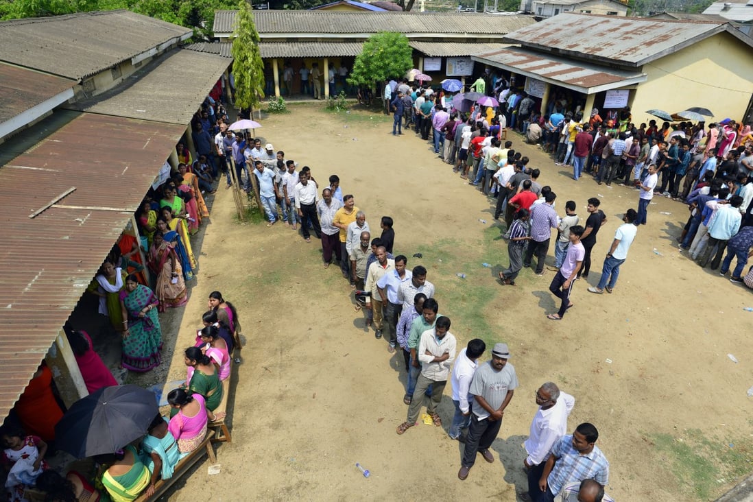 Voters queue at a polling station in Guwahati, Assam, on April 23. Photo: EPA