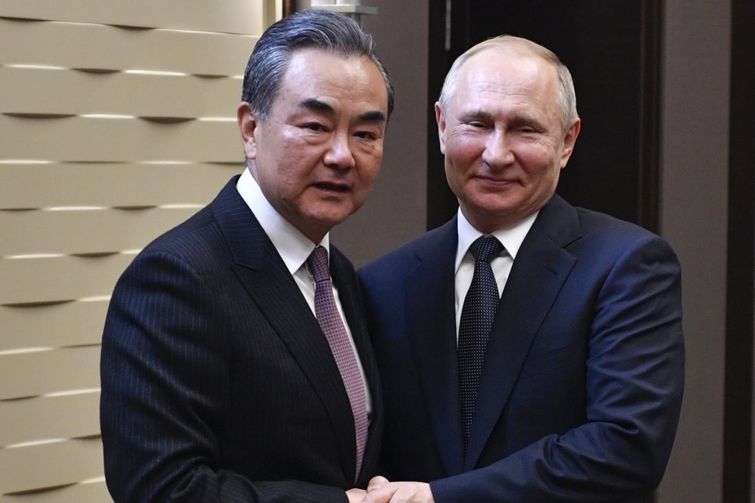 Chinese Foreign Minister Wang Yi with Russian President Vladimir Putin in Sochi on Monday. Photo: AP