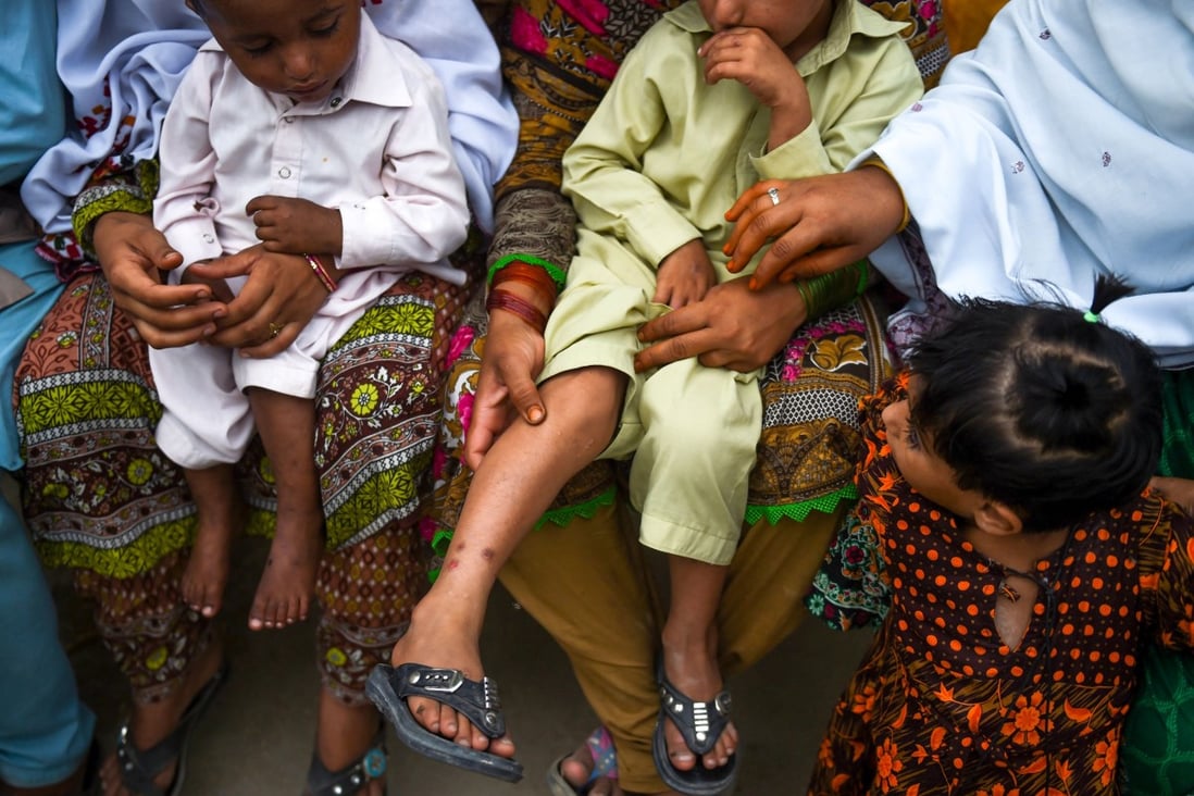 Pakistani women hold their HIV-infected children. Photo: AFP