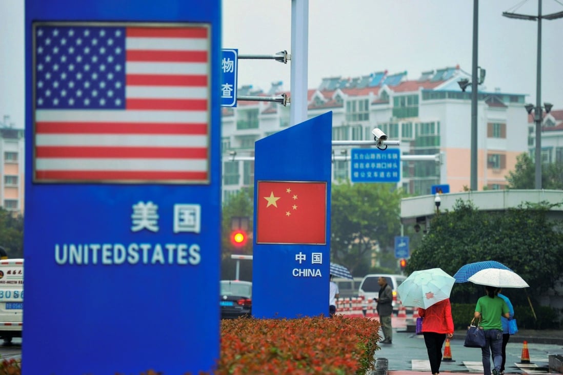 Signs with the US flag and Chinese flag are seen outside a store selling foreign goods in Qingdao in China's eastern Shandong province on September 19, 2018. – China on September 18 announced tariffs on US goods worth $60 billion in retaliation for President Donald Trump's decision to slap duties on $200 billion in Chinese products next week. Photo: Agence France-Presse
