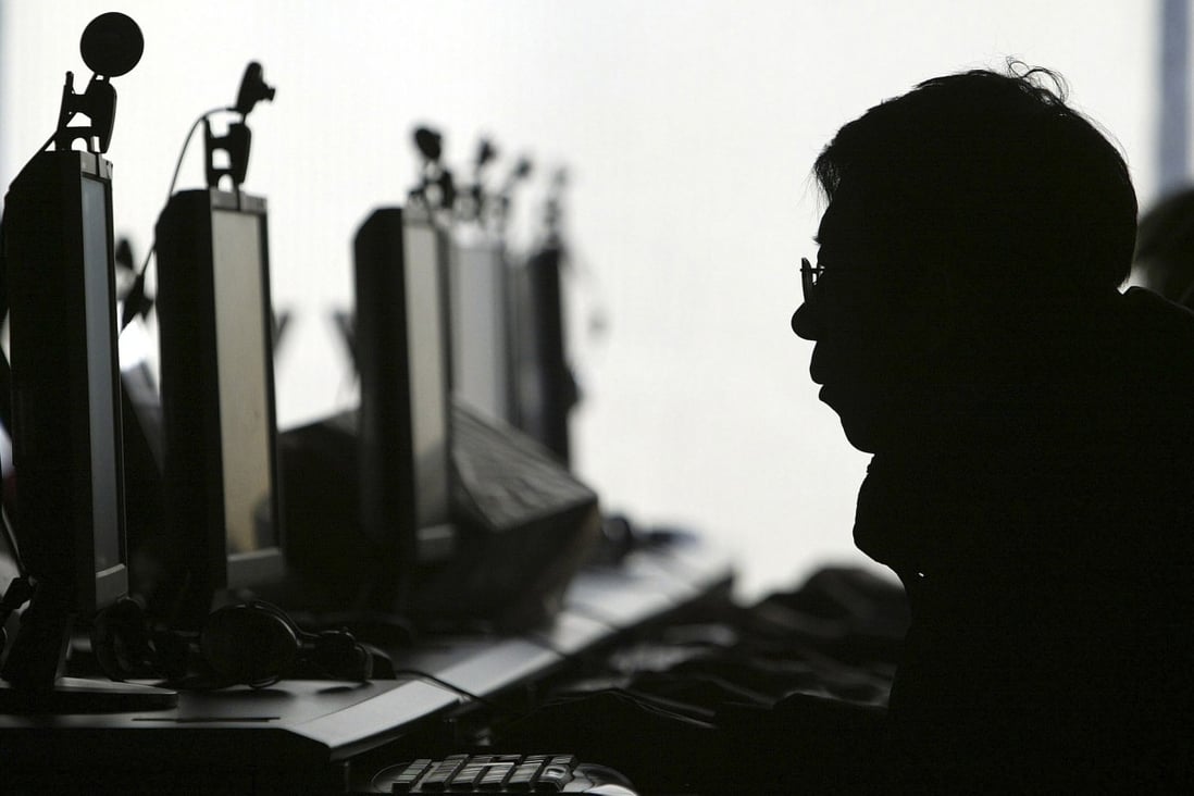A person sits at a computer monitors at an Internet cafe. Live-streaming websites are the front in the battle against online paedophiles in Southeast Asia. Photo: AP