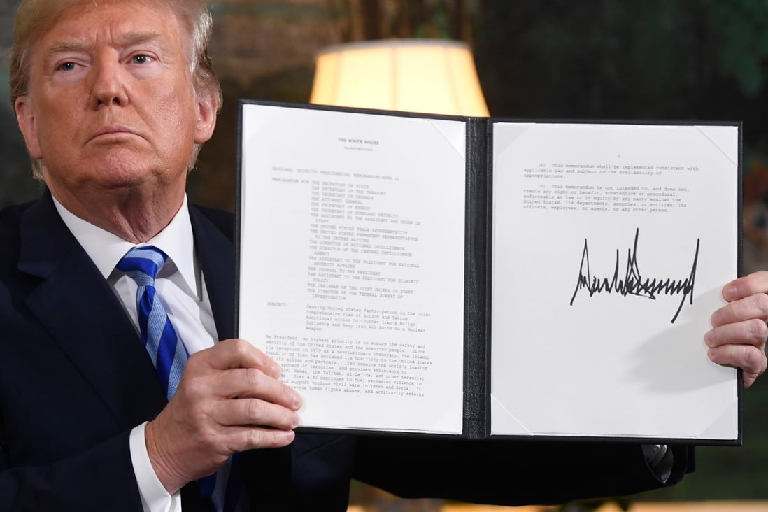 US President Donald Trump signs a document reinstating sanctions against Iran after announcing the US withdrawal from the Iran nuclear deal, at the White House in Washington on May 8, 2018. Photo: AFP
