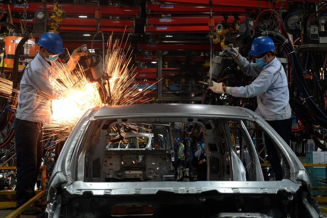 Vietnamese employees weld at a car plant in Hai Duong. The country stands to gain from the US-China trade war. Photo: AFP