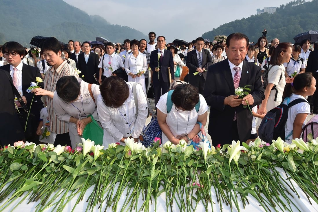 Followers of the Unification Church lay flowers in tribute to Reverend Sun Myung Moon. Photo: AFP